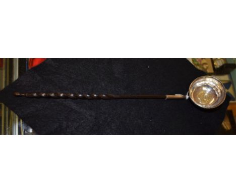 An 18th century silver punch ladle, inset with Queen Anne coin, baleen handle