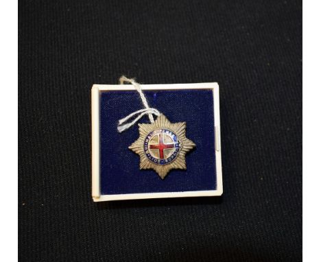 A silver and enamel badge, Latin inscription