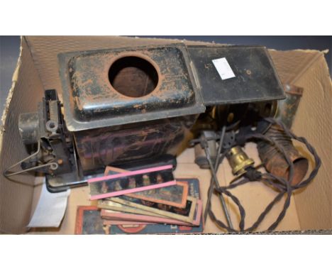 A child's magic lantern with oil lamp and accessories; a selection of hand tinted and other painted glass slides 