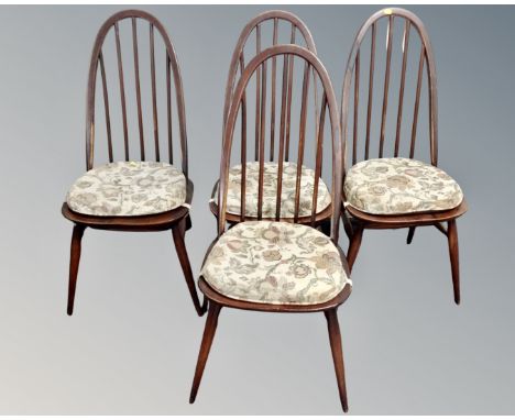 A set of four Ercol stained elm and beech stick back dining chairs