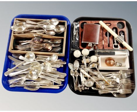 Two trays containing a large quantity of plated flatware, cutlery caddy, hip flask, wine bottle stoppers and kits.