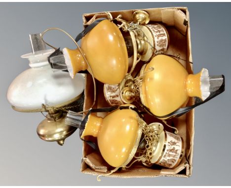 A set of three electric light fittings in the form of oil lamps with glass chimneys and shades together with a further hangin