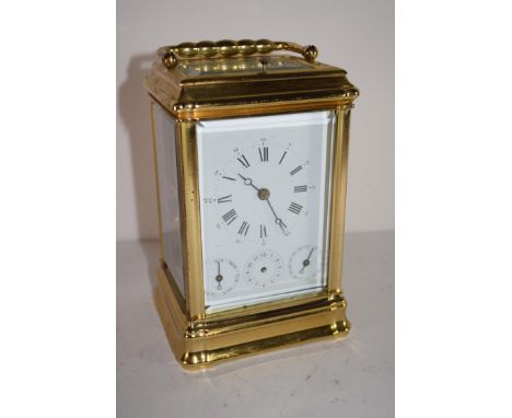 Carriage clock with subsidiary dials for seconds and days of the week
