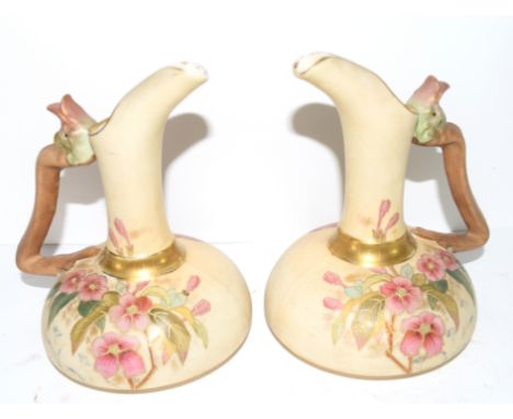 Pair of Continental ewers modelled in  Royal Worcester style with the blush ground with floral decoration, handles modelled a
