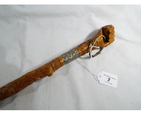 A good quality carved walking stick with white metal collar the woodwork carved with depictions of birds, animals and oak and