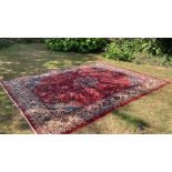 Carpets: A good red ground Wilton Persian rug, cost when new approx. £1500. 111ins. x 151½ins.