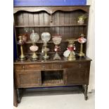 Early 20th cent. Stained oak dresser with two shelves, two drawers and two cupboards on turned