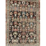 Rugs & carpets: Late 19th cent. Persian rug, black ground central panel decorated with stylised