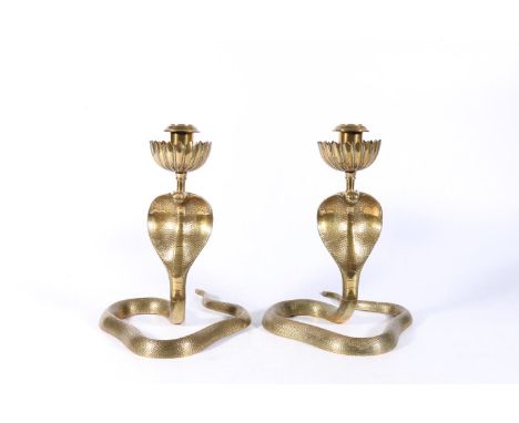 Pair of Indian 'Benares' brass candlesticks in the form of cobras, the eyes picked out in ruby coloured plastic or resign, 22