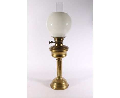 Brass paraffin lamp with milk glass shade, 64cm tall. 
