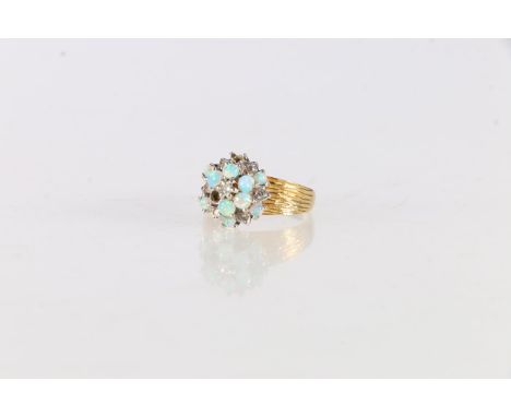 18ct gold opal and diamond set flowerhead ring, size K, 4.8 grams. 