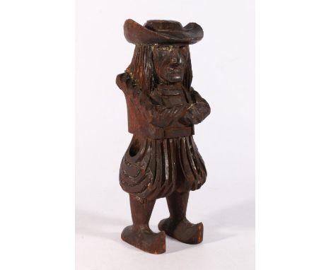 Carved wood statue or candlestick in the form of a gentleman wearing clogs, probably Black Forest, 23cm tall. 