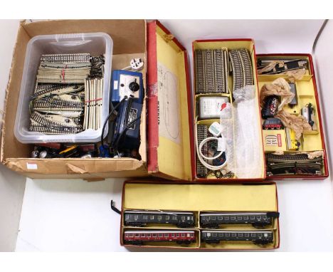A quantity of unboxed Marklin HO gauge wagons and track, together with two part complete Marklin sets, both with locos and st