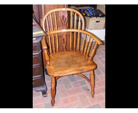 An antique stick back country armchair with crinoline stretcher 