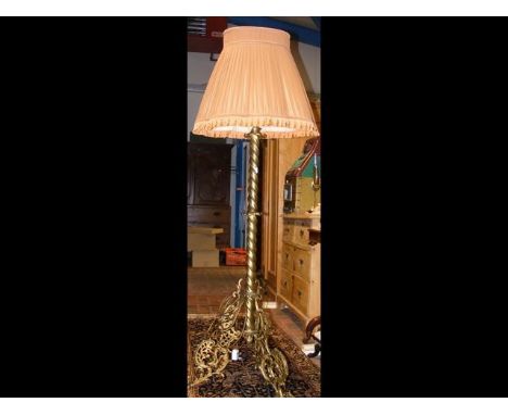 An adjustable brass standard lamp with shade 