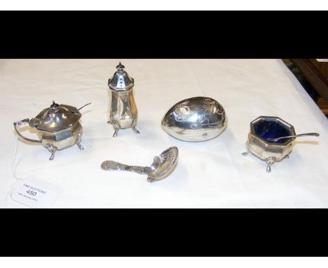 A three piece silver condiment set, silver caddy spoon and continental white metal egg shaped dish 