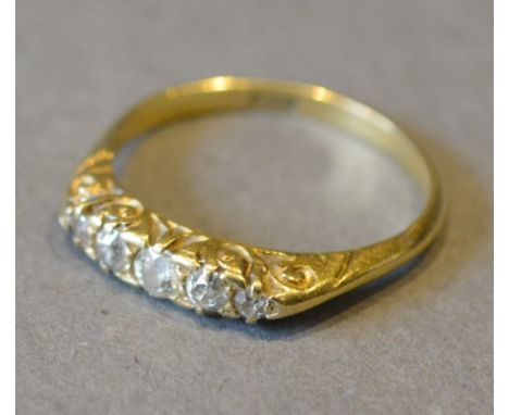 An 18ct. Yellow Gold Diamond Ring set with five graduated diamonds within a pierced setting