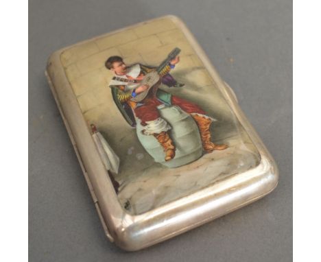 A Victorian Silver and Enamel Decorated Cigarette Case, the hinged cover depicting a figure in period dress playing a guitar,