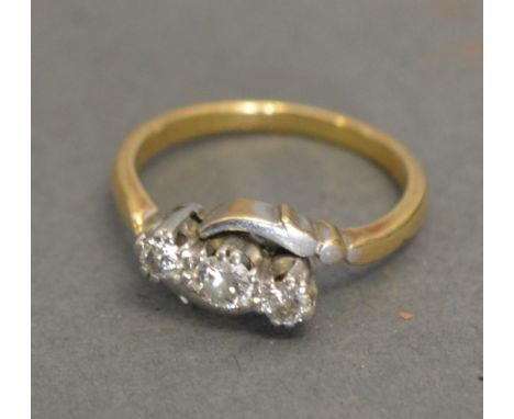 An 18ct. Yellow Gold Three Stone Diamond Ring with Crossover Setting