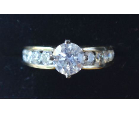 An 18ct. Yellow Gold Solitaire Diamond Ring, the claw set diamond approximately 1.53ct., the diamond shoulders within a pierc