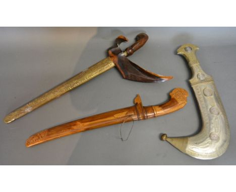 A 19th Century Kris with Hardwood and Brass Scabbard together with a white metal jambiya with coins inset and another similar