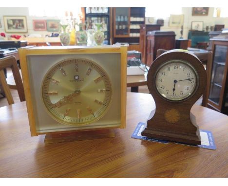 An Edwardian balloon shape table timepiece, the case with patera inlay, enamelled dial, 8 day spring movement, 22 cm high, an