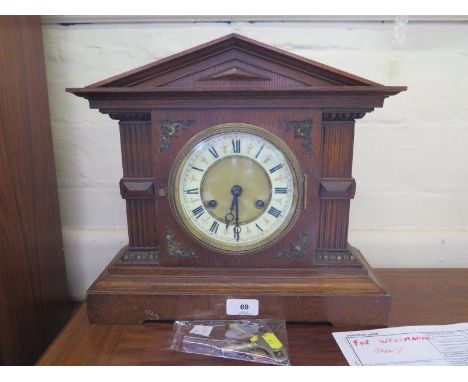 An Edwardian oak mantel clock, of architectural form, with cream chapter ring, the Junghans movement striking on a gong, 36 c