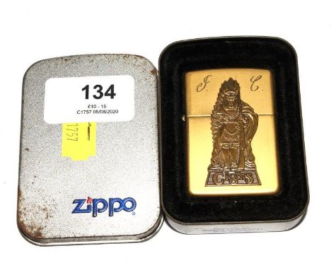 An Indian Chief Cigars brass Zippo lighter, with engraved initials, and tin box 