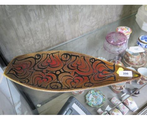 A Poole Pottery Aegean boat shape dish, the flowerhead motif in brown and orange, 44 cm long 