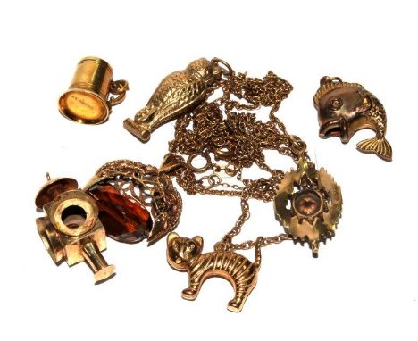 A selection of gold charms to include a spinning seal, a lantern, an owl, etc 