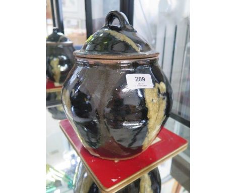 A Bernard Leach Pottery lidded pot, by Trevor Corsar, of bulbous form with domed lid and cream motif black and green glaze, 2