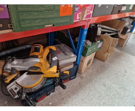 A collection of tools to include a compound mitre saw, socket set, circular saw, roller stand, wood saws, tile cutter, large 