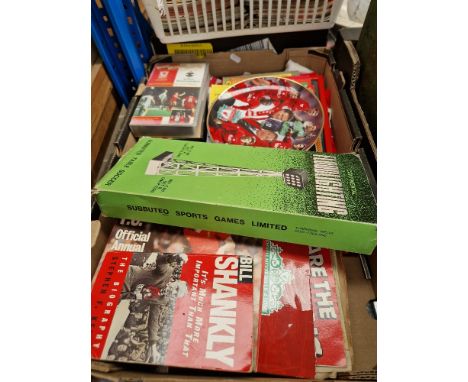 A box containing Liverpool FC memorabilia including programes, newspapers, commemorative plate, flags, Subbuteo floodlights, 