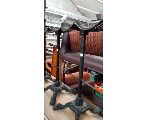 A pair of cast iron tractor seat bar stools, height 82cm (overall).  