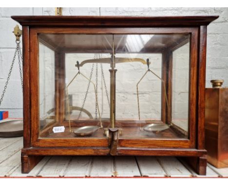 A set of scales in wood &amp; glass display case.