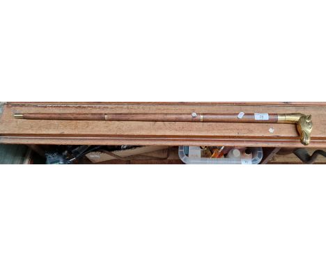 A sectional walking stick with brass fittings, horses head handle and concealed drinking vessel.  