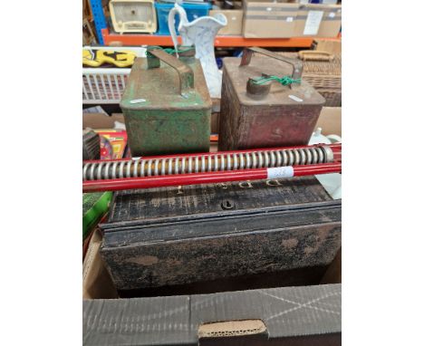 Two vintage petrol cans, one Shell and another, together with a metal deed/money box and a vintage Kelo Pogo stick .  