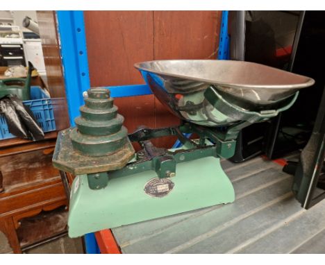 A set of green enamel scales for the Co-operative Society with weights, circa 1930s.  