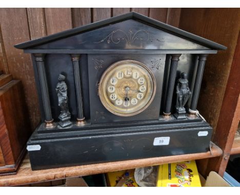 A late 19th century black slate mantle clock, with key.  