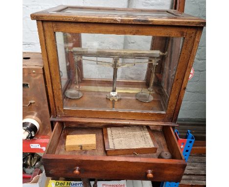 A set of scales in wood &amp; glass display case.