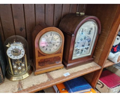 A bracket clock, a mantle clock, keys and pendulums present and a quartz clock.  