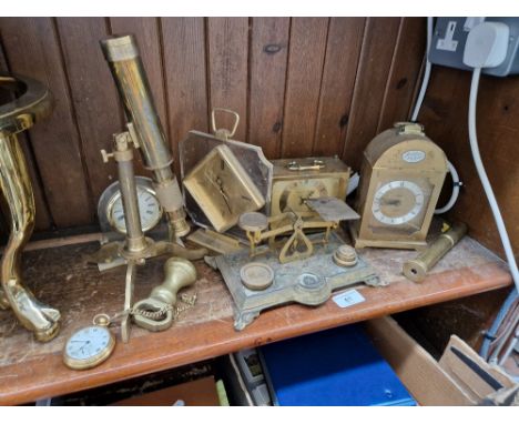 A collection of brass items to include weighing scales with weights, telescopes and brass  faced clocks  