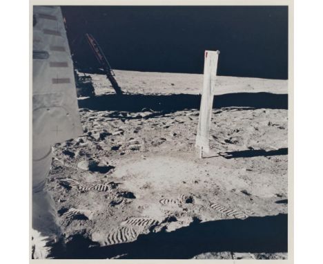 Buzz Aldrin An extremely rare sighting of Neil Armstrong on the Moon walking out at left with the Solar Wind Collector and th