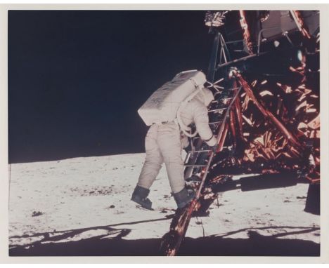 Neil Armstrong Buzz Aldrin walks down the ladder as he prepares to take his first steps on the surface of the Moon, Apollo 11