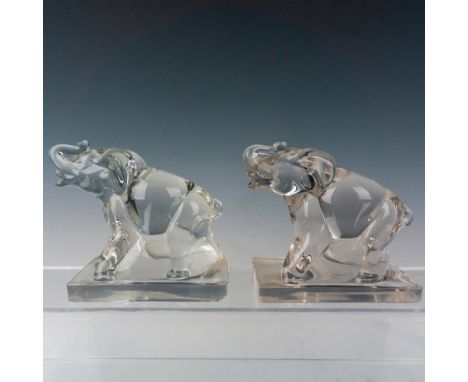 Sparkling glass bookends depicting adorable elephants with trunk up on rectangular base. Dimensions: 3"L x 5.5"W x 5.5"HManuf