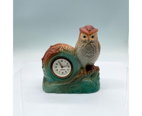 Introduced in 1927, pastel teal and brown matte finished ceramic clock with owl on a branch overlooking the manual winding cl