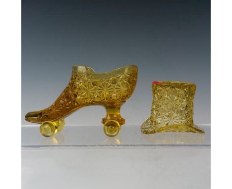 Amber colored glass top hat vase and roller skate vase decorated in the Daisy Button pattern. Top hat vase measures: 3"W x 2.