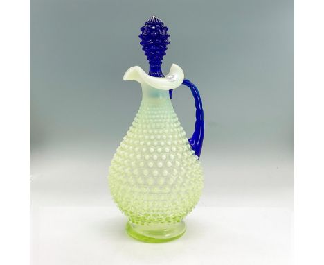 Vaseline glass pitcher decanter with raised hobnail design, bright cobalt blue handle and stopper. Fenton label. Dimensions: 