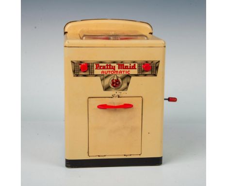 Vintage tin toy washing machine showcasing hand-crank movement, complete with an agitator and spinning basket. The front disp