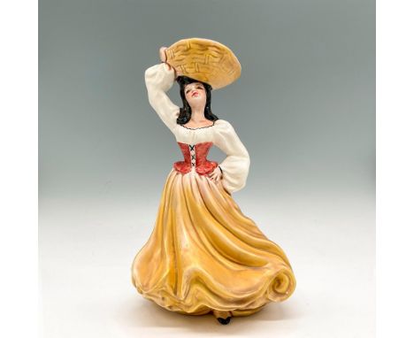 Matte finished figural dressed in yellow flowing skirt with peasant blouse cinched at waist, carrying a basket on her head. F